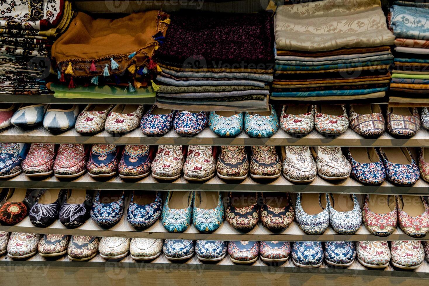Eastern beautiful Market sells local traditional clothes, fabrics on shelf of store photo