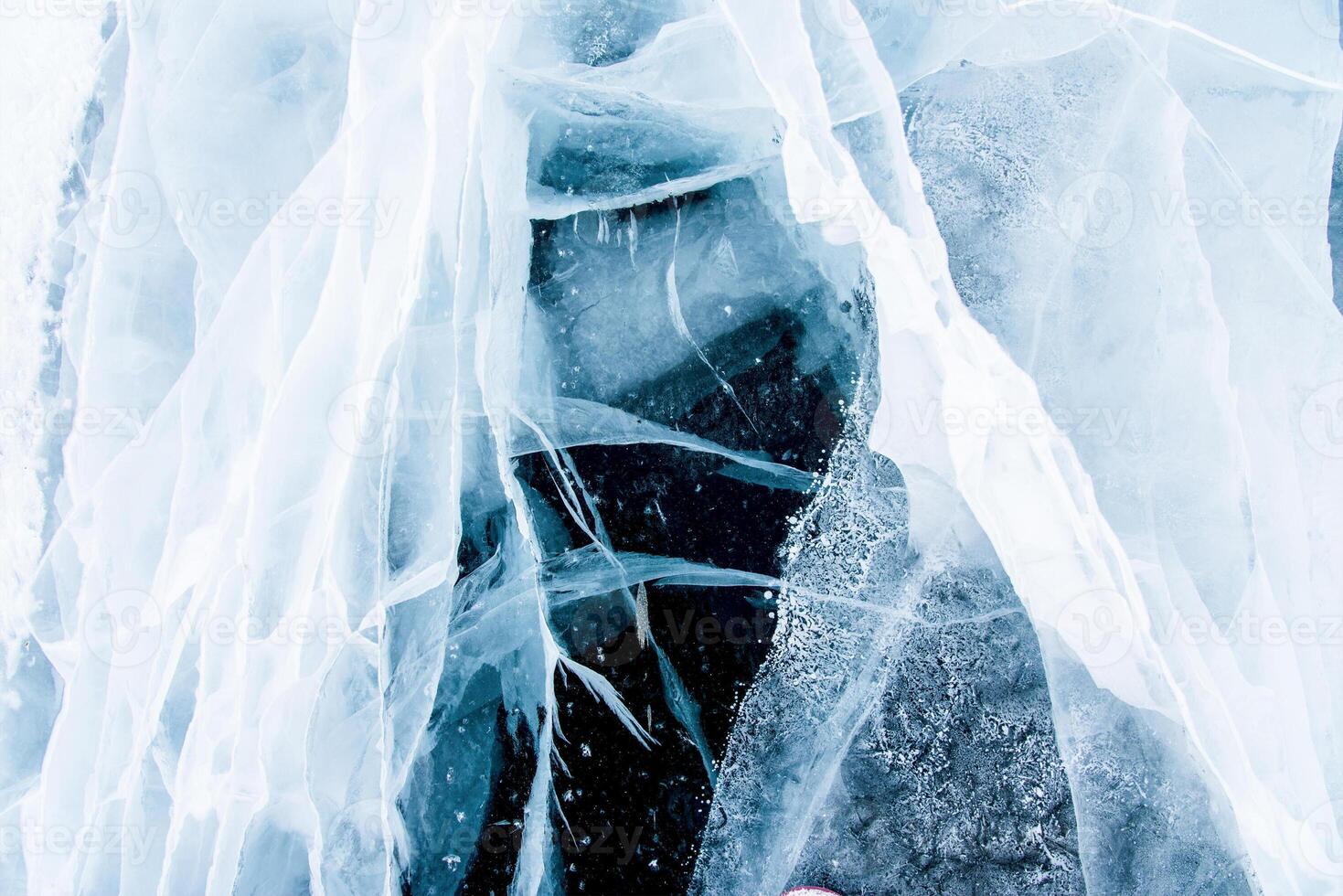 Deep blue thick ice texture, lake water frozen in winter, icy wallpaper, white snow photo