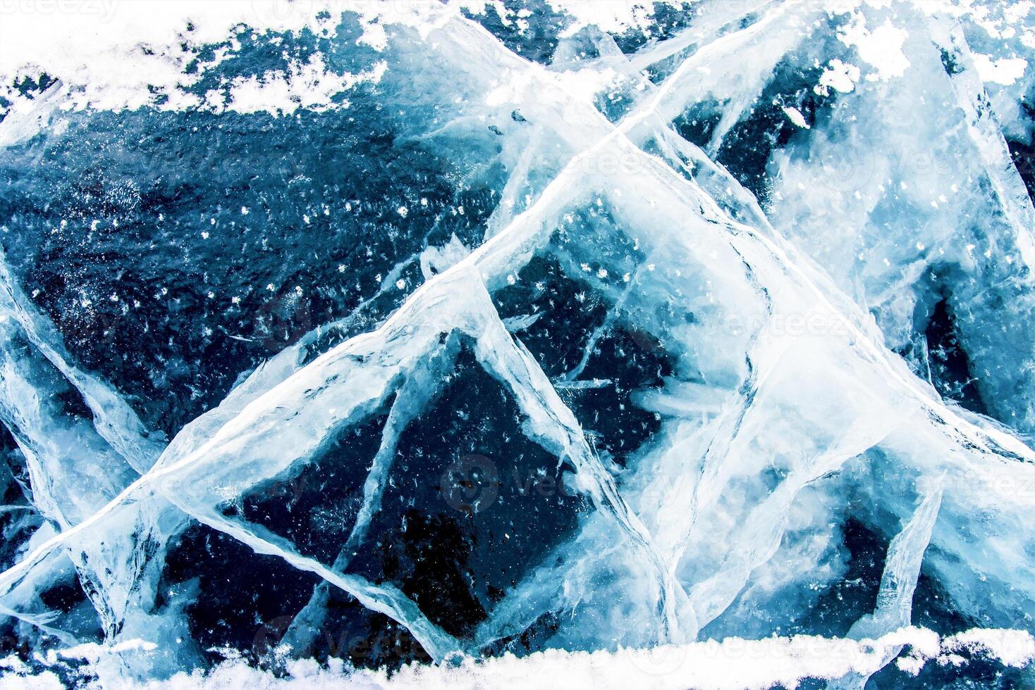 Deep blue ice cold texture, lake water frozen in winter, icy wallpaper, white snow photo