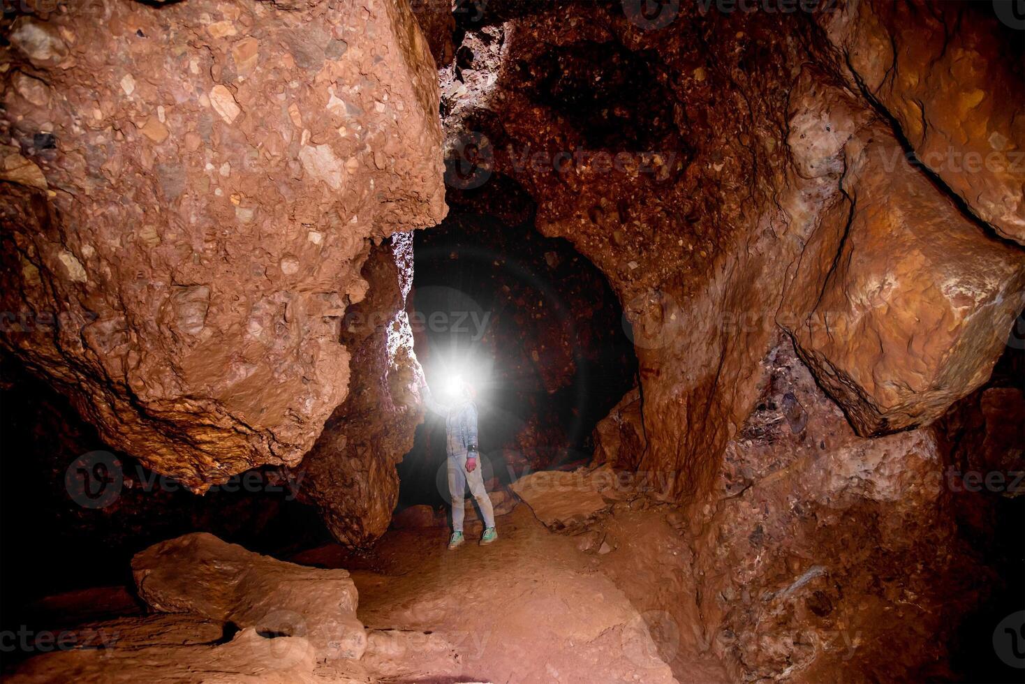 Speleologist journey explores an underground cave, geologist studies hole rock mountain photo