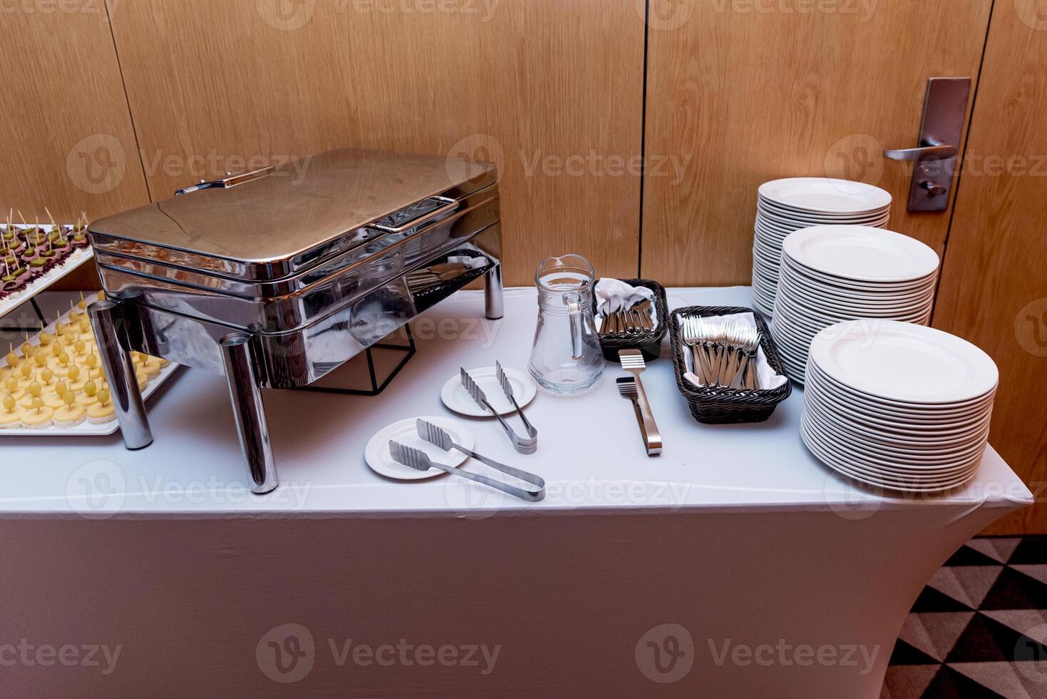 Buffet hotel restaurant, coffee break event food stand on table white savory tablecloth photo