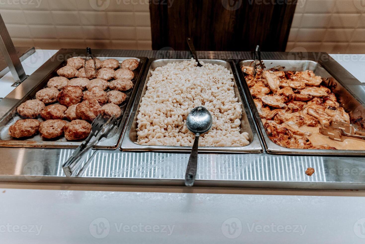 Buffet savory in hotel restaurant, various food dishes on tray, dinner in dining room photo