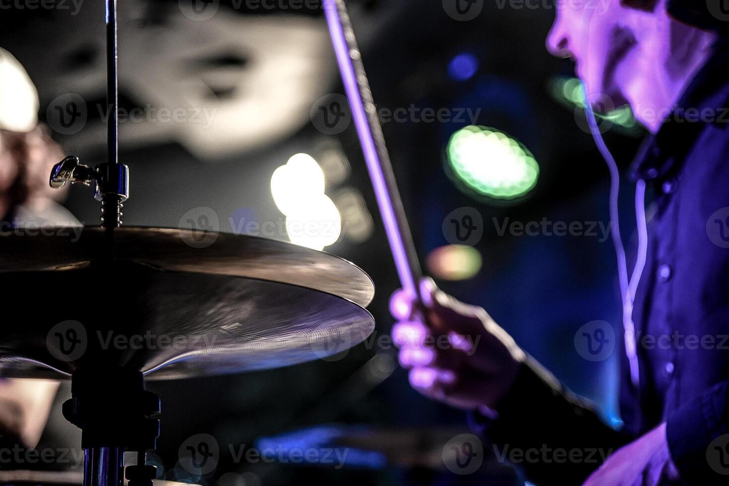 Man play drum kit, musician drummer performs at concert in nightclub bar photo