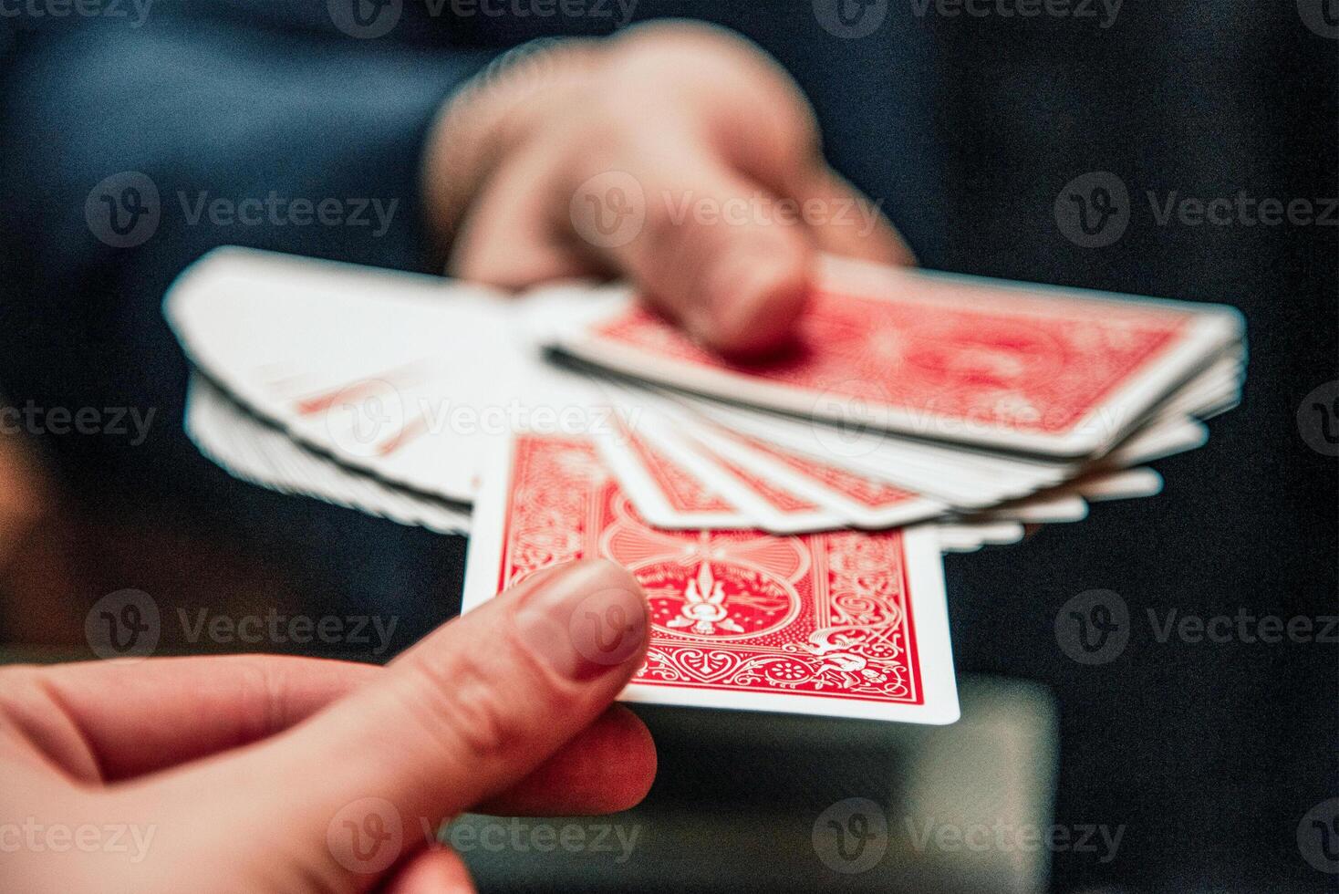Magician show card trick, man play casino nice gambling, close up hands holding deck photo