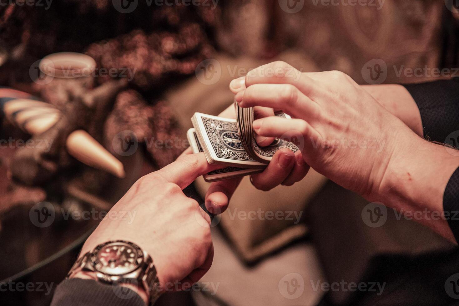 Magician show card trick, man play nice casino gambling, close up hands holding deck photo