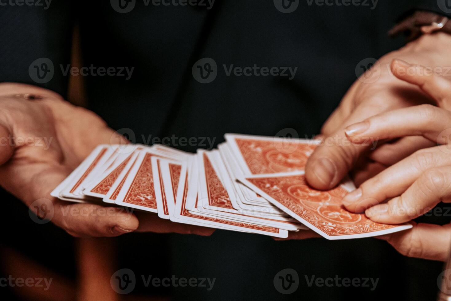 Magician show card nice trick, man play casino gambling, close up hands holding deck photo