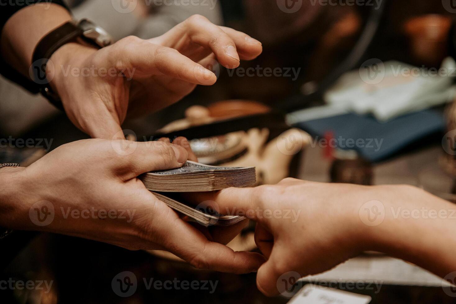 Magician nice show card trick, man play casino gambling, close up hands holding deck photo