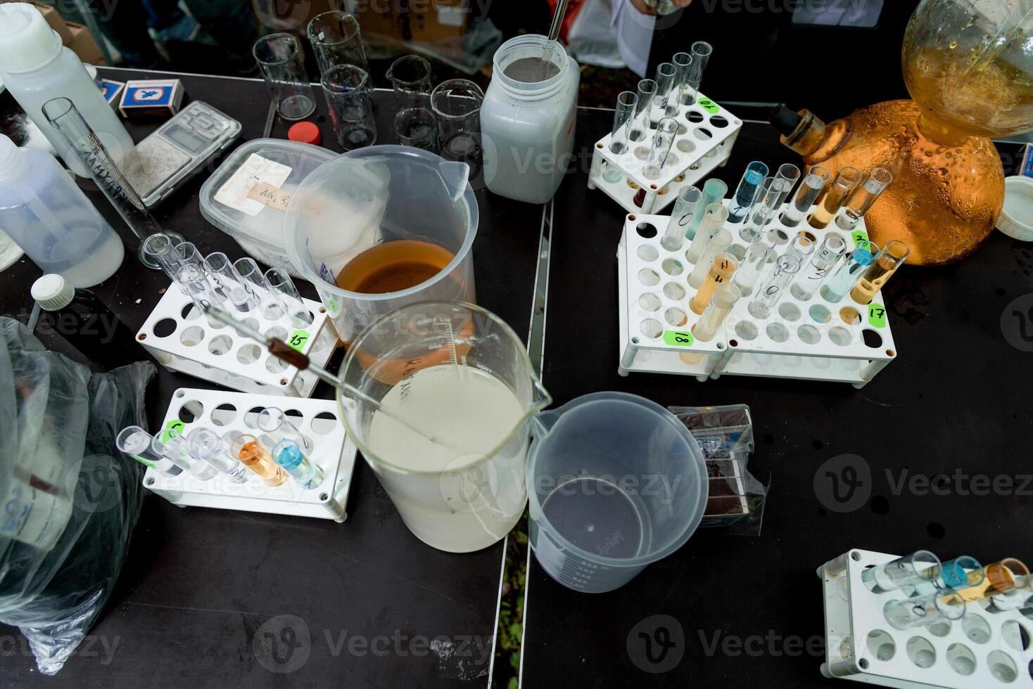 Scientist in laboratory pour smart liquid glass flask, assistant conduct an experiment photo