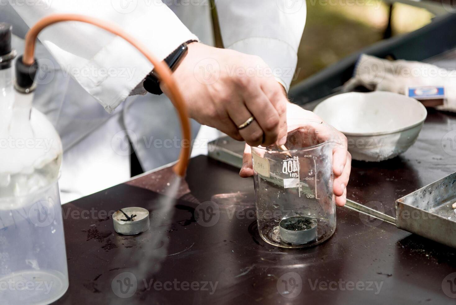 Scientist in smart laboratory pour liquid glass flask, assistant conduct an experiment photo