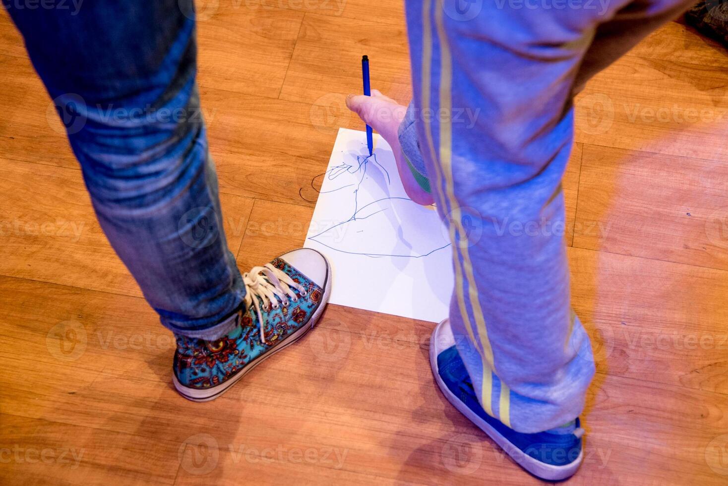 Child lovely draw foot felt tip pen on paper, kid in kindergarten, preschool education photo