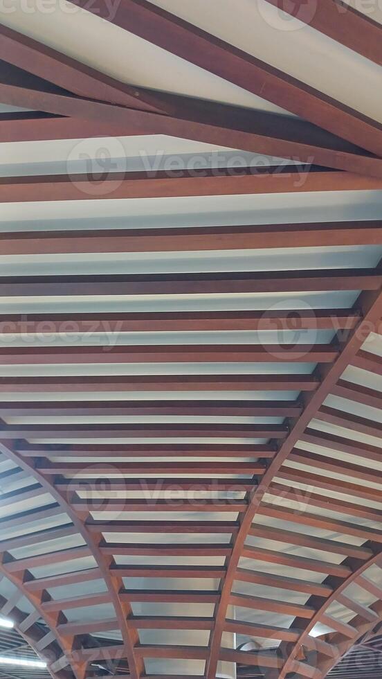 A wall with wooden slats and a window photo