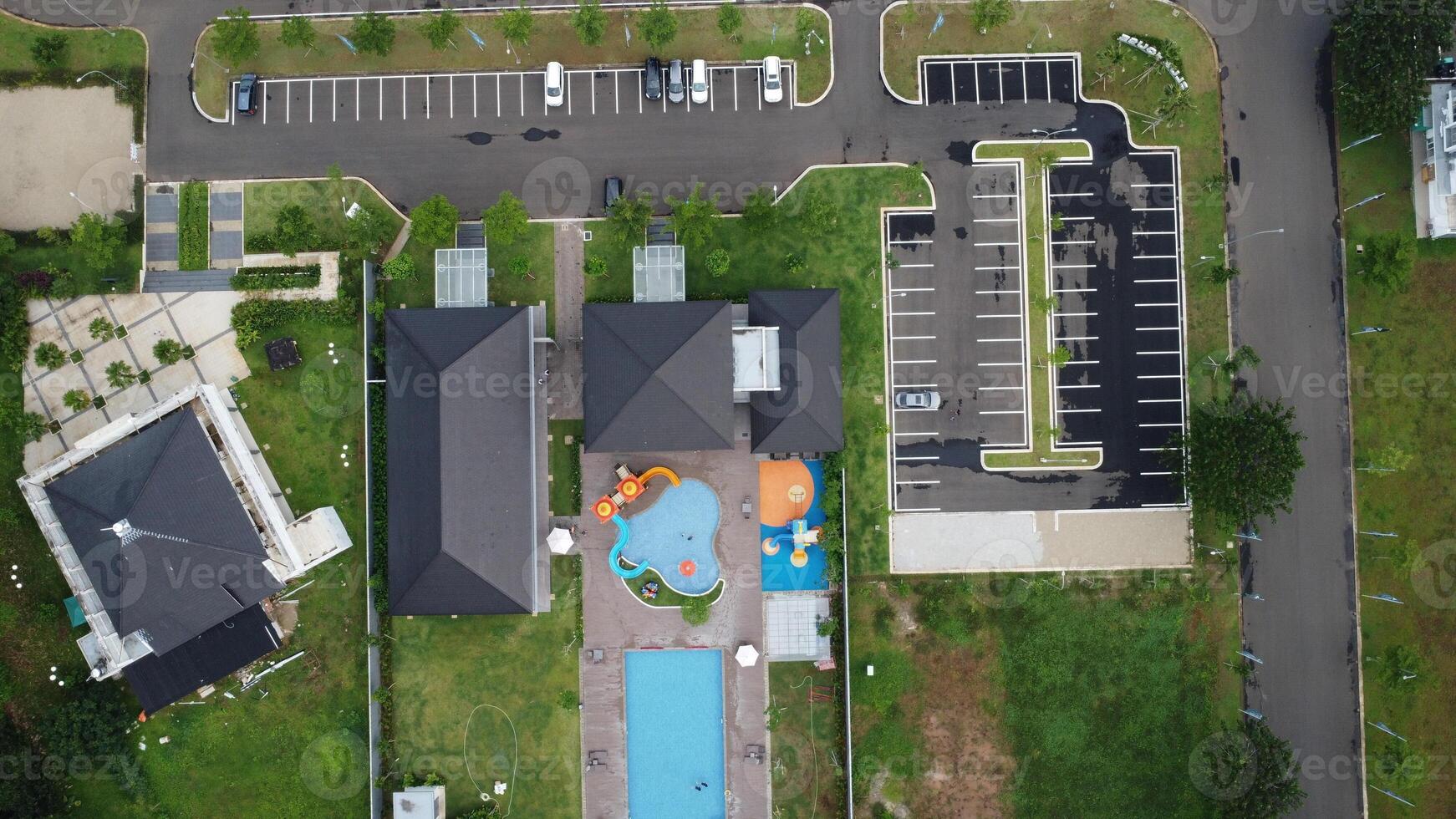 An aerial view of a residential complex with a swimming pool photo