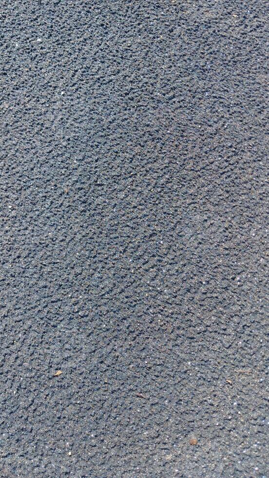 A close up of a black surface with a white spot photo