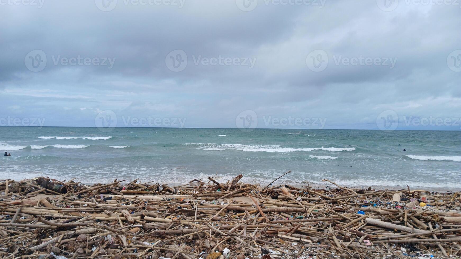 A beach with debris and a person on the beach photo