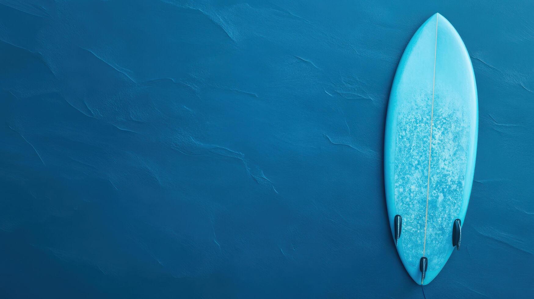 Surfboard resting on a calm blue surface under bright lighting in a serene coastal environment photo