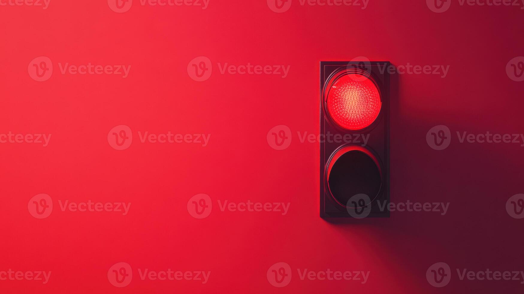 Bright red traffic light signals to stop on a minimalistic background during daylight hours in a modern urban setting photo