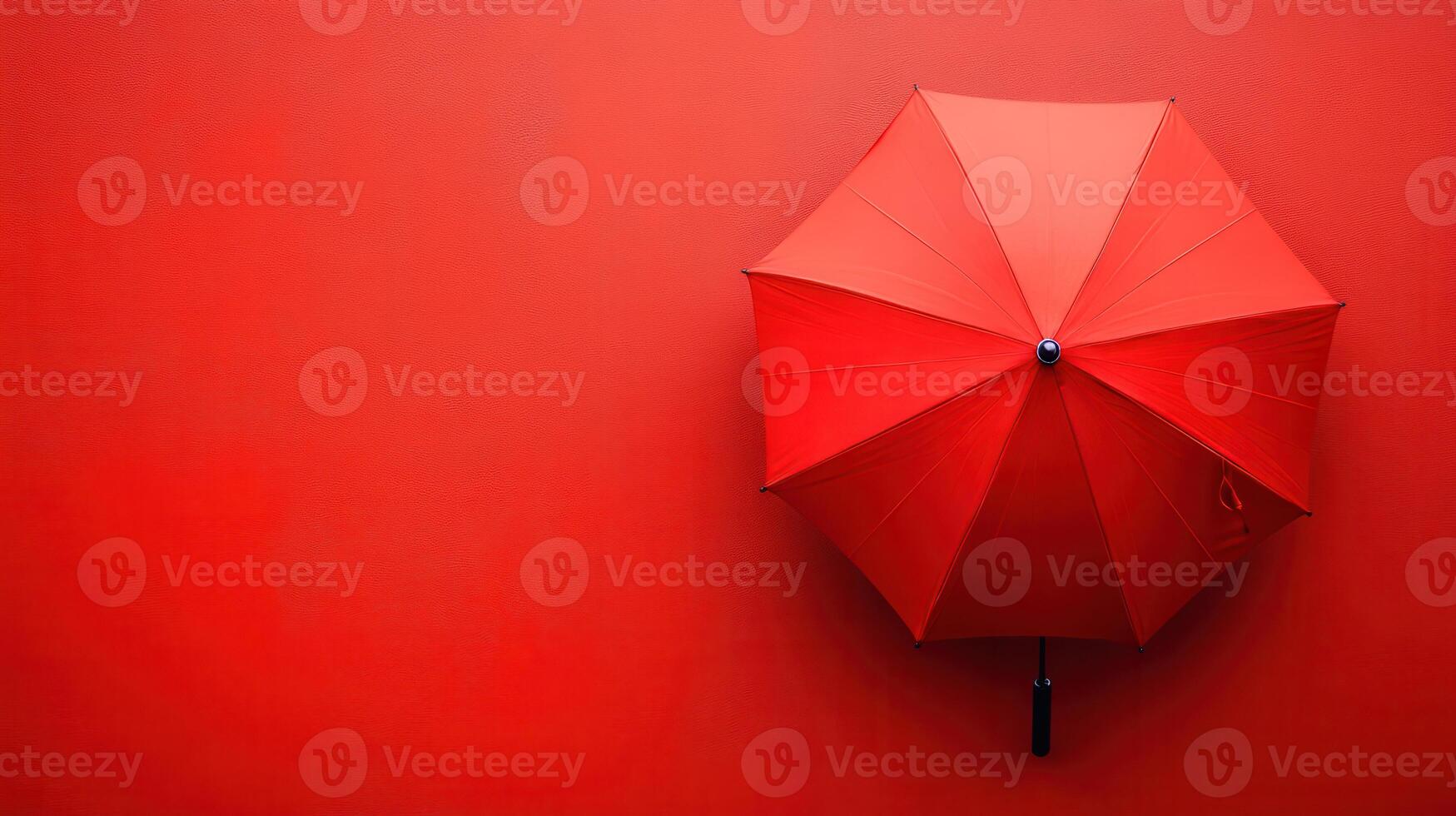 Bright red umbrella against a vibrant red wall creating a striking visual contrast photo