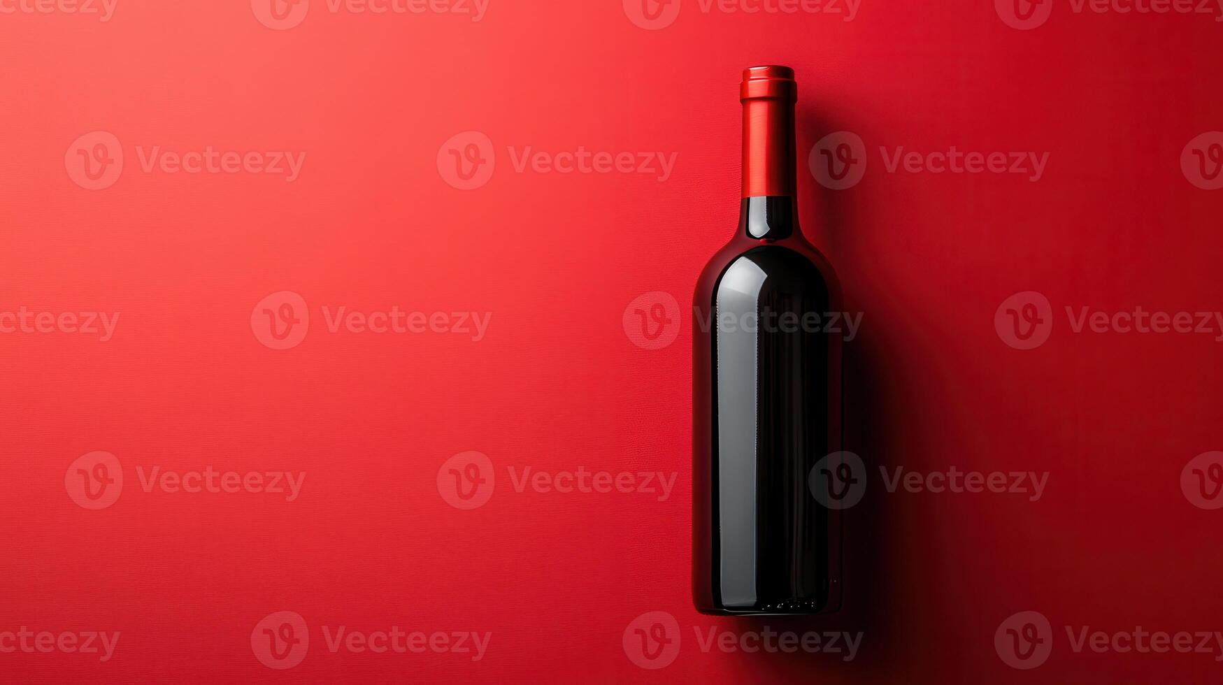 Elegant red wine bottle placed on a vibrant red background showcasing simplicity and sophistication photo