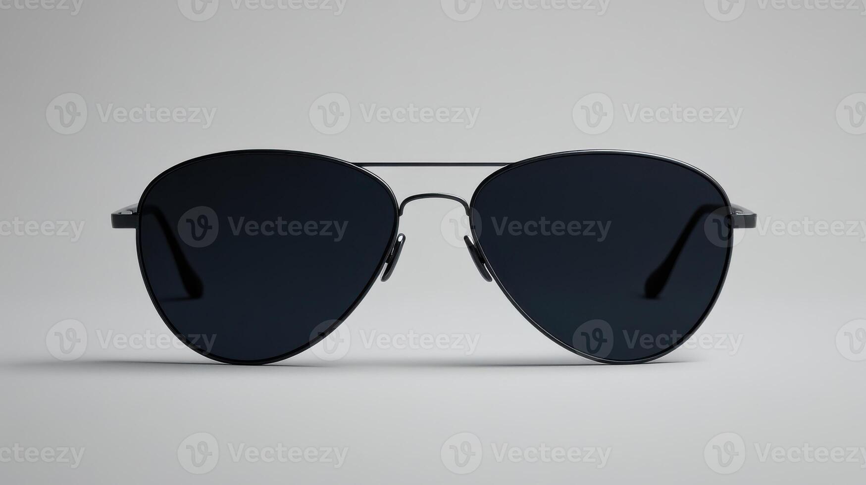 Stylish black aviator sunglasses placed on a smooth surface showcasing modern design with no reflections or distractions photo