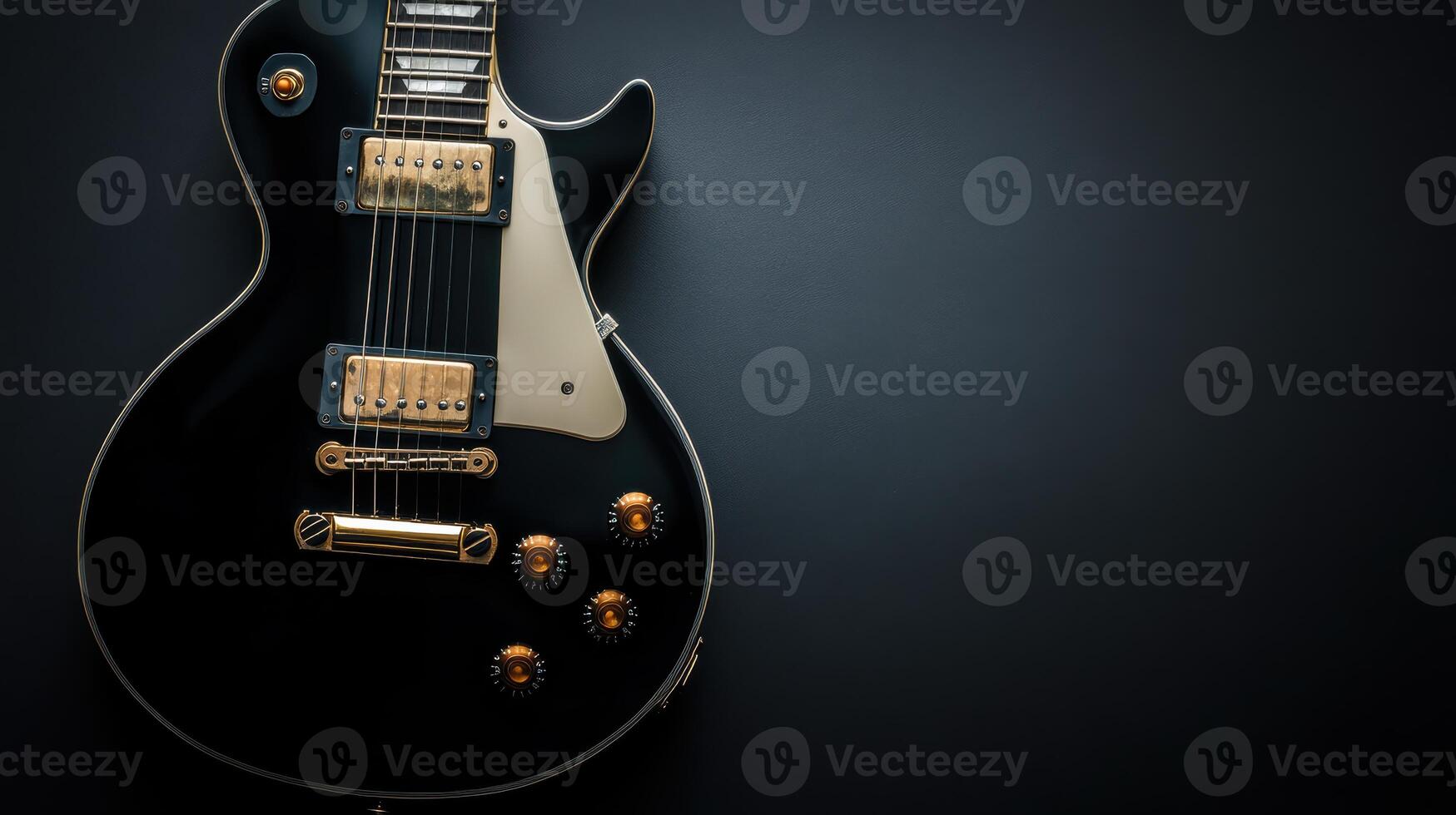 Black electric guitar resting on a dark surface with polished chrome hardware and elegant design photo