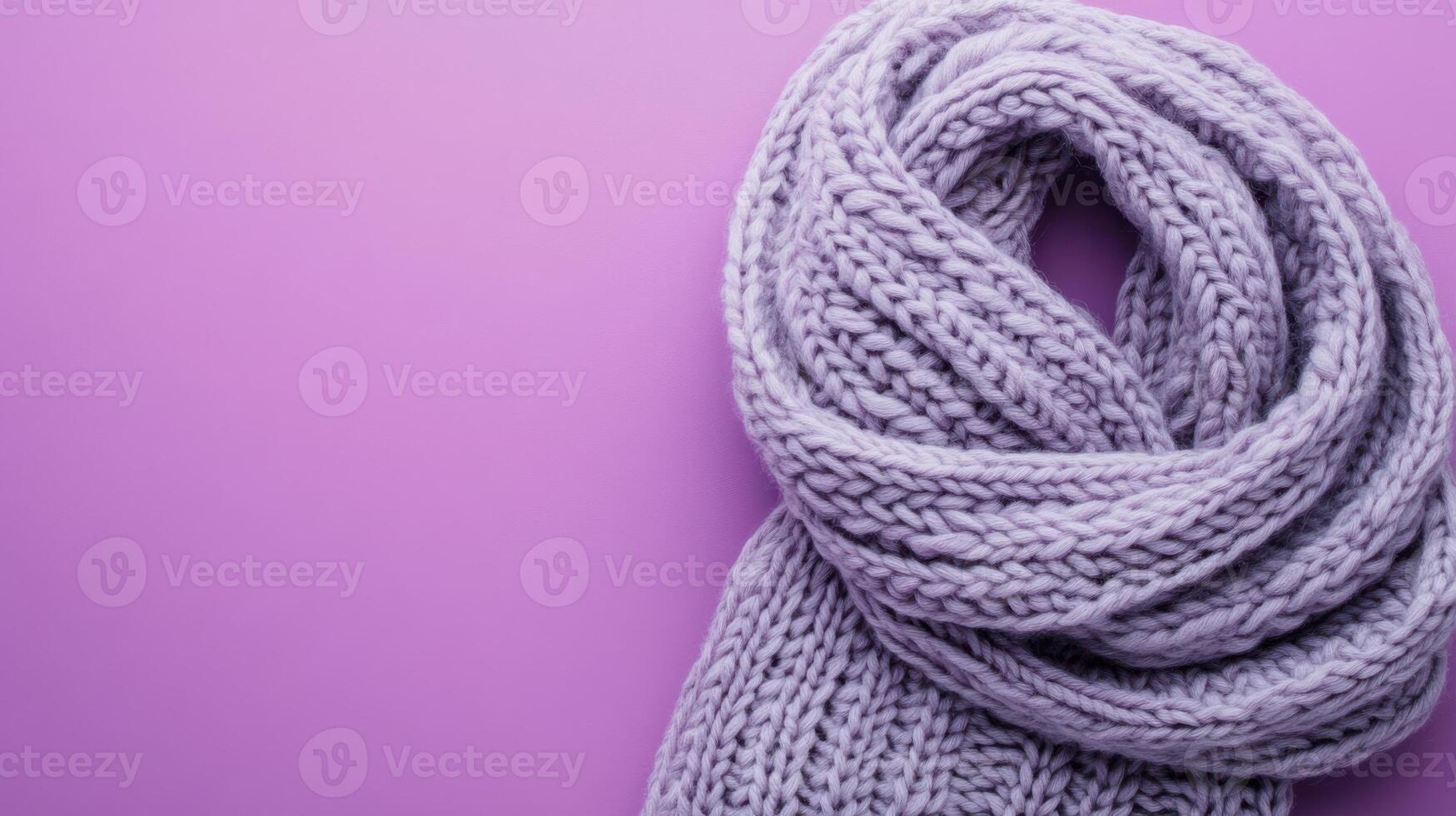 Warm purple knitted scarf on a pastel background showcasing texture and color ideal for winter fashion photo