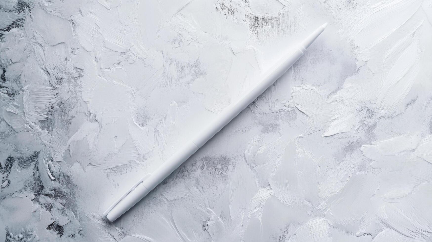 Simple white pencil resting on textured gray surface during creative drawing session in a studio photo