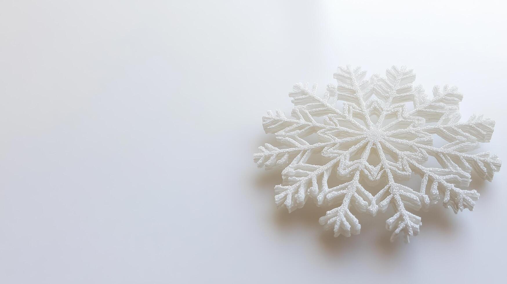 Unique white snowflake design displayed on a simple background highlighting winter elegance and seasonal charm photo