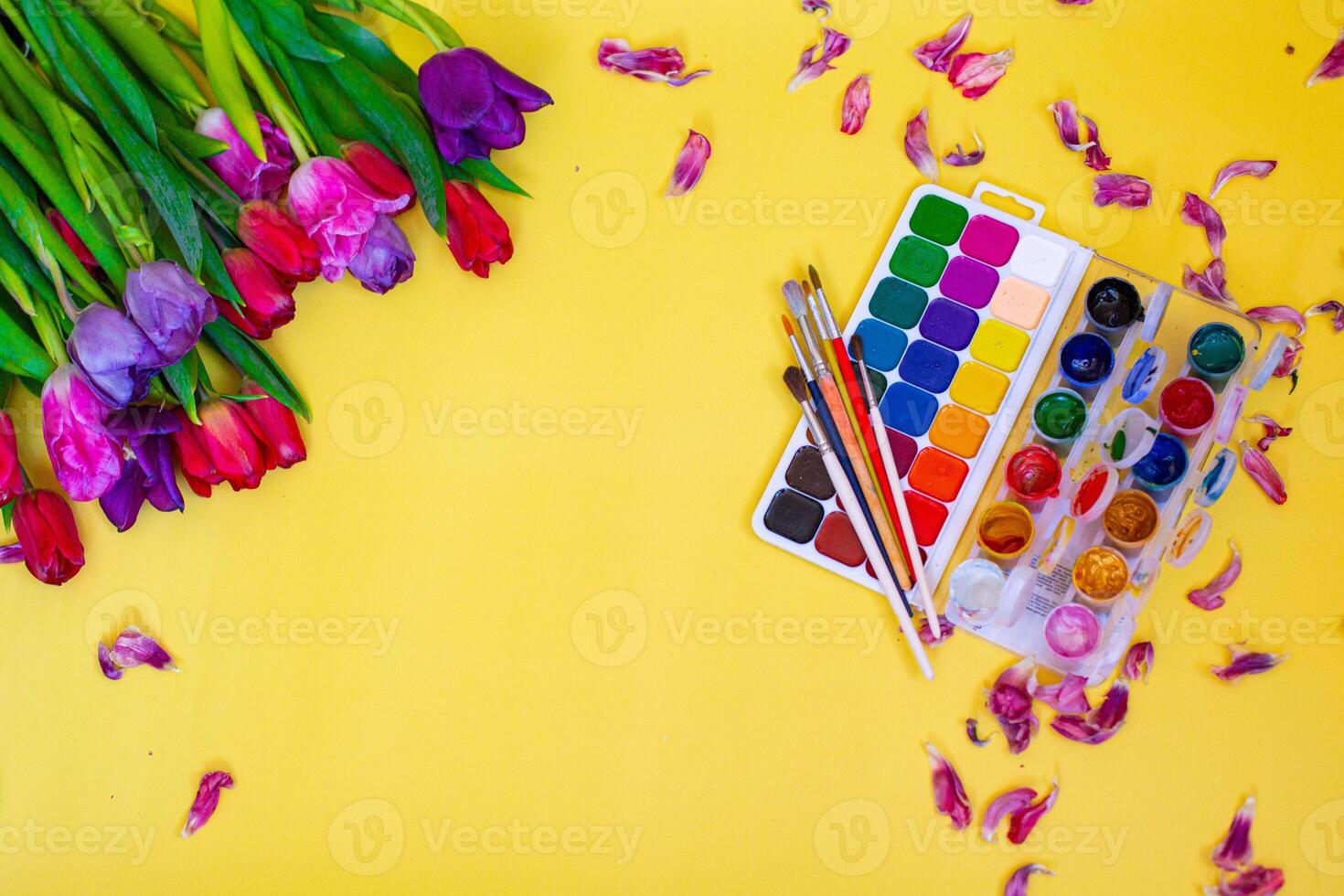 ayout with aquarelle palette on yellow background photo