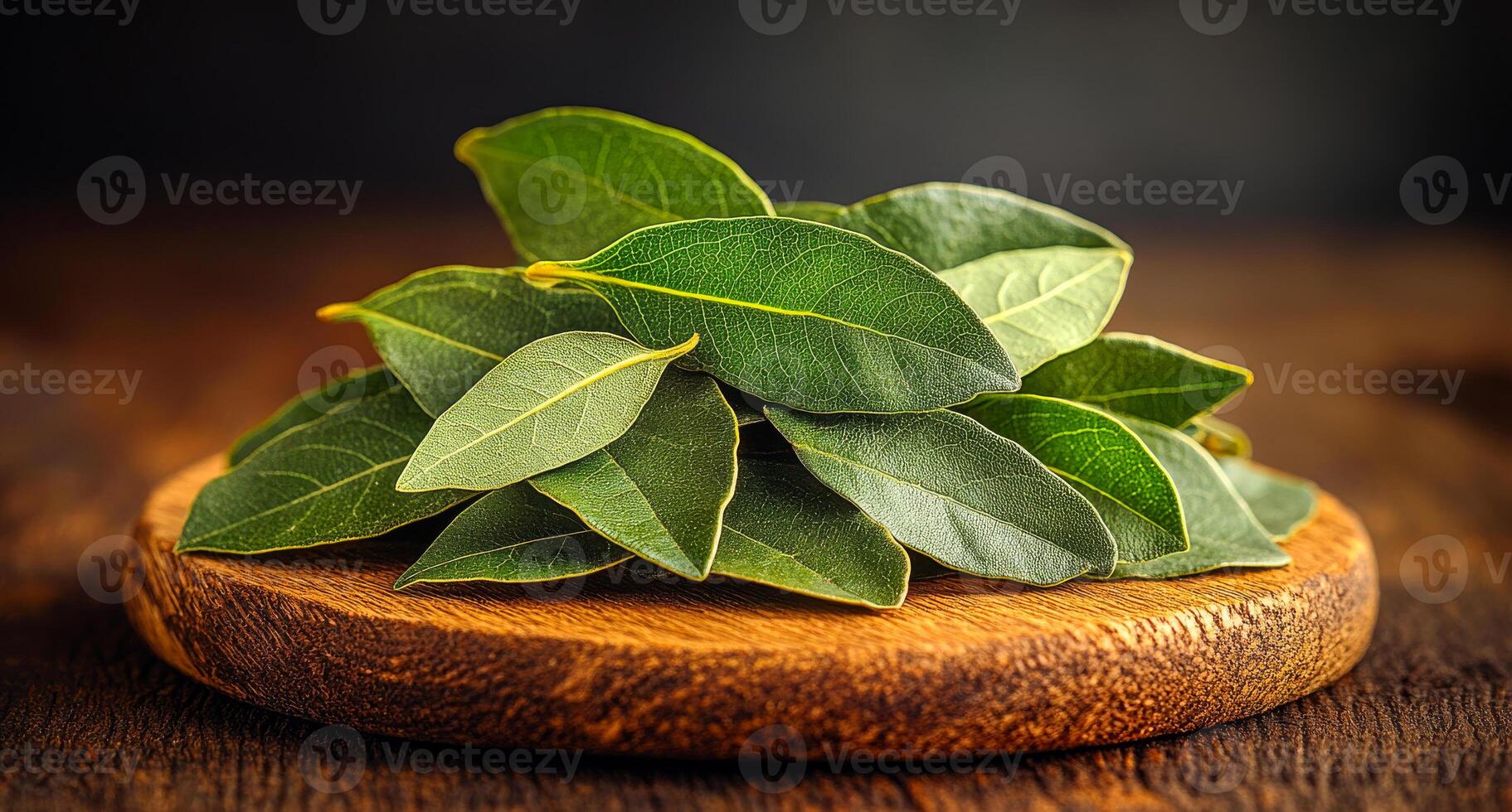 A pile of green leaves on a wooden cutting board. The leaves are fresh and appear to be from a tree photo