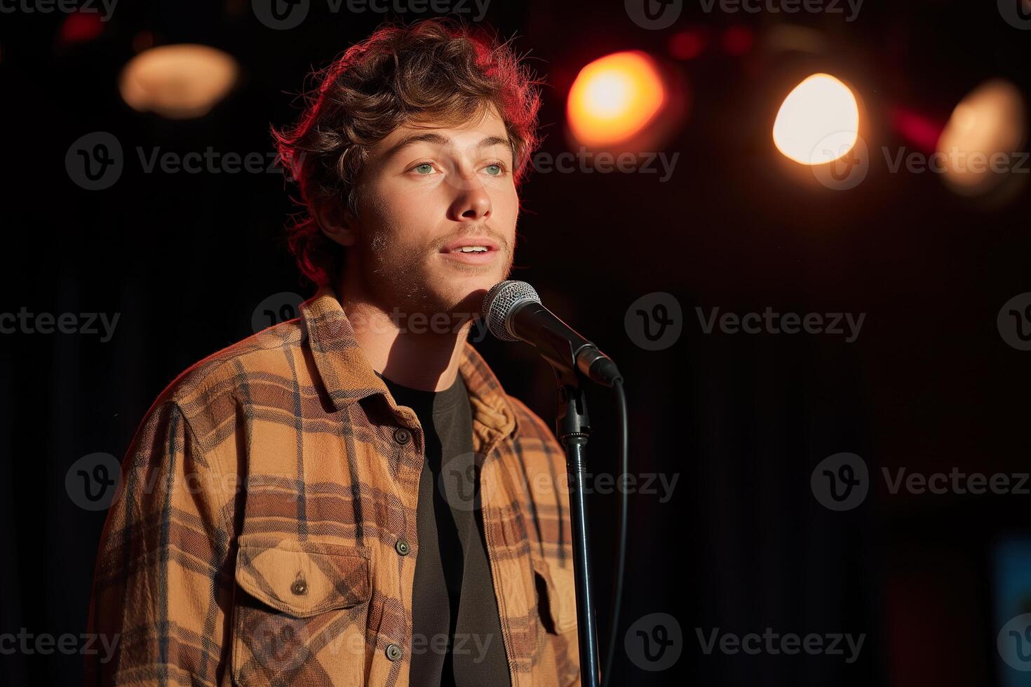 A performer entertains the audience with humorous takes on daily routines under warm stage lights. photo