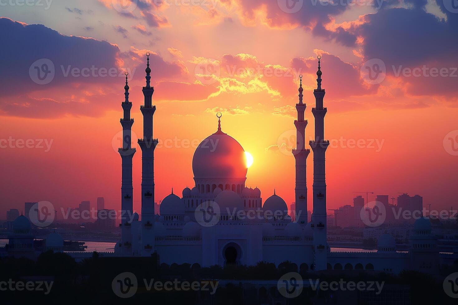 The vibrant sunset casts colorful hues behind a majestic mosque, highlighting its intricate architecture and minarets photo