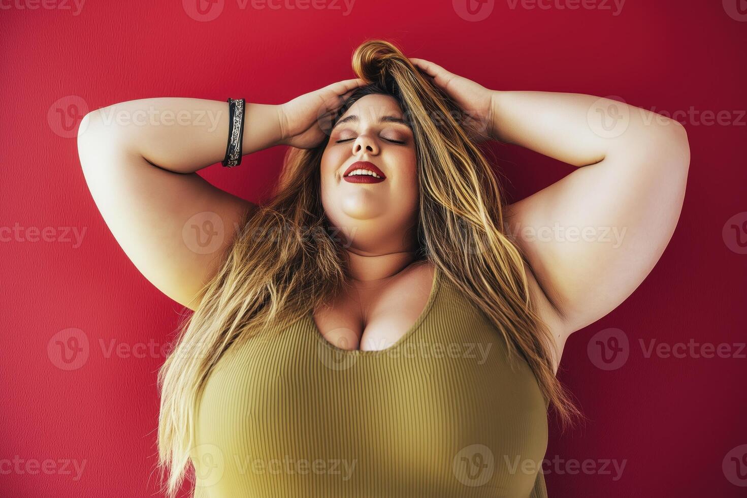 Portrait of a joyful drag queen laughing against a vibrant red background in a colorful and lively atmosphere photo