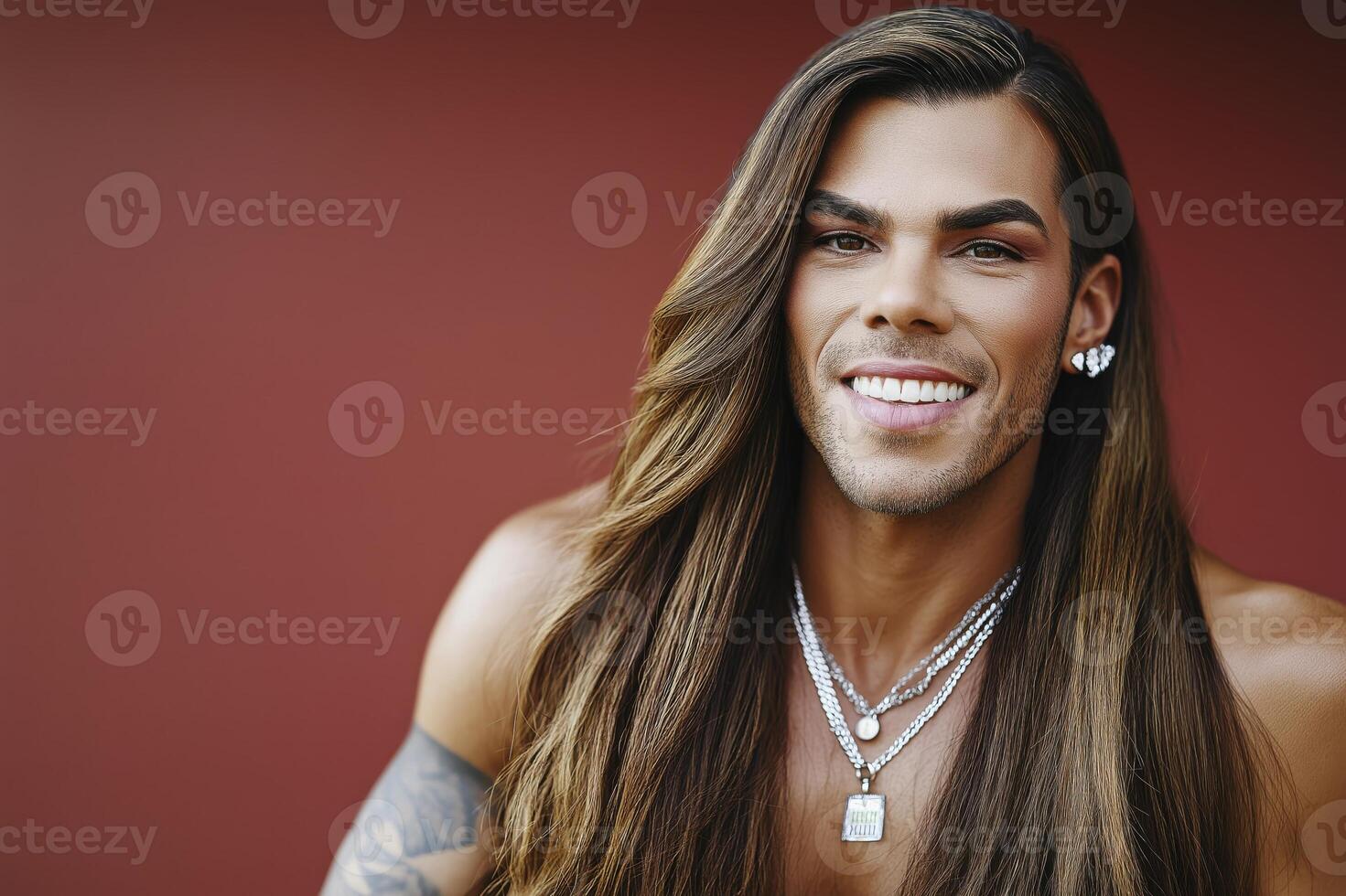Joyful drag queen shares laughter against a vibrant red backdrop in a striking portrait photo