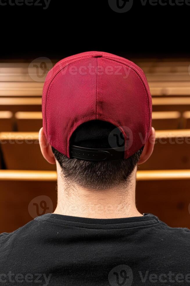 Rear view of a man wearing a maroon baseball cap photo