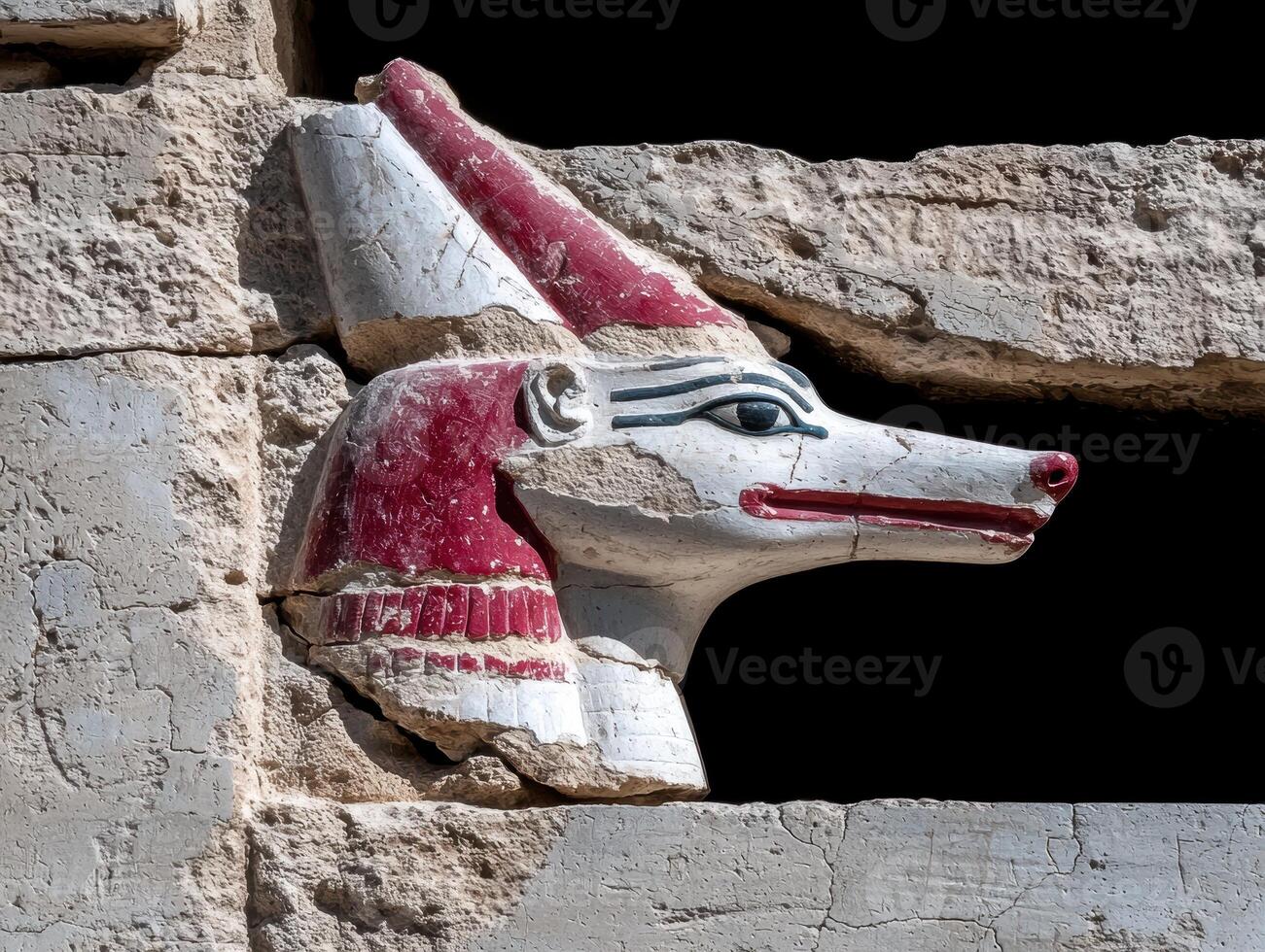 Ancient Egyptian deity Anubis statue detail in a temple wall photo