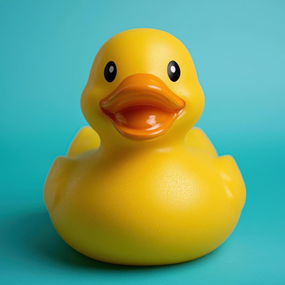 Yellow rubber duck on a teal background photo