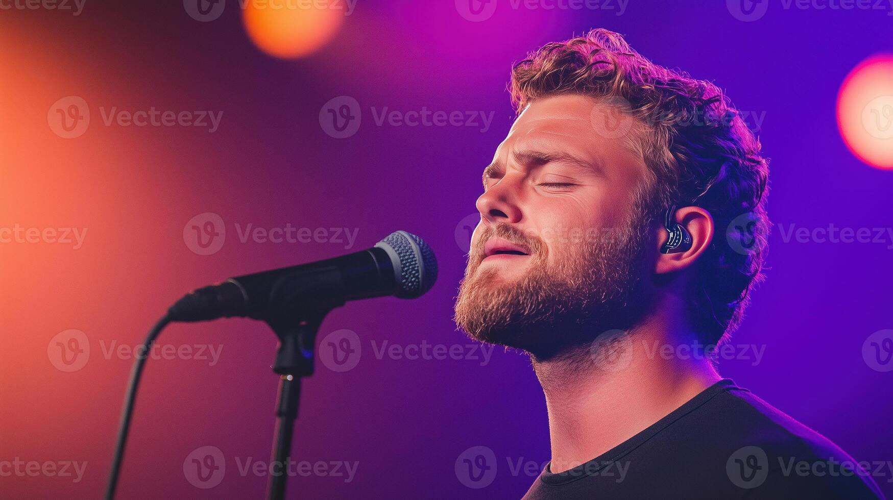 Singer with Cleft Palate Performing on Stage Under Vibrant Lighting at a Concert with Microphone and Emotional Expression photo