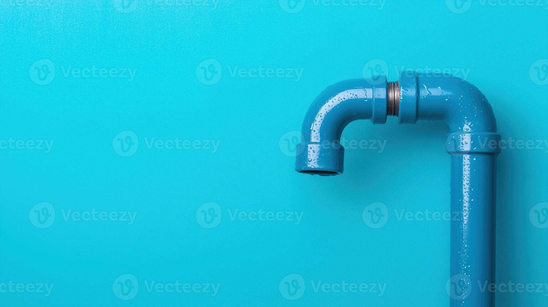 Blue water pipe with elbow joint and water droplets on a turquoise background. Close-up image. Plumbing and utility concept. photo