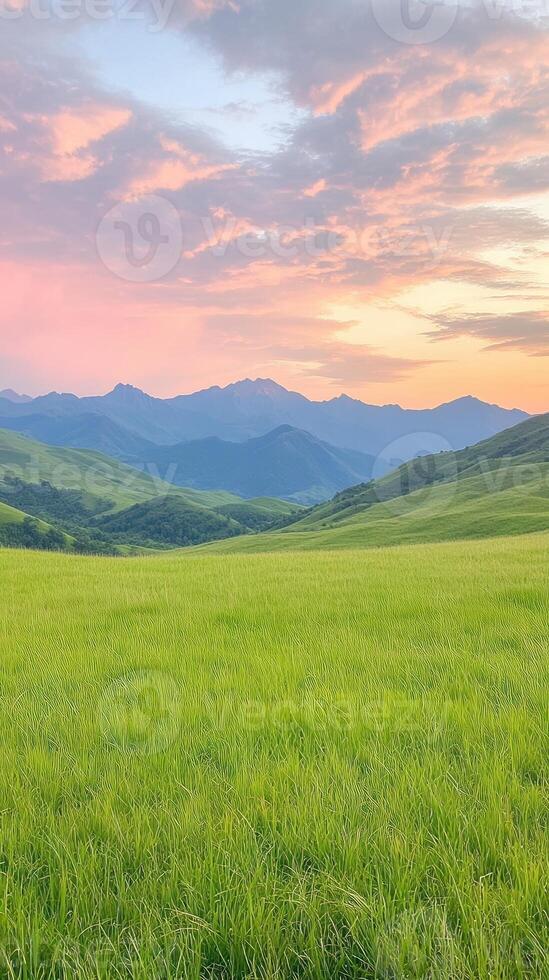 Serene Mountain Range at Sunset with Lush Green Fields and Dramatic Sky Enhancing Tranquility and Natural Beauty in Vertical Composition for Inspirational Nature Photography and Decoration photo