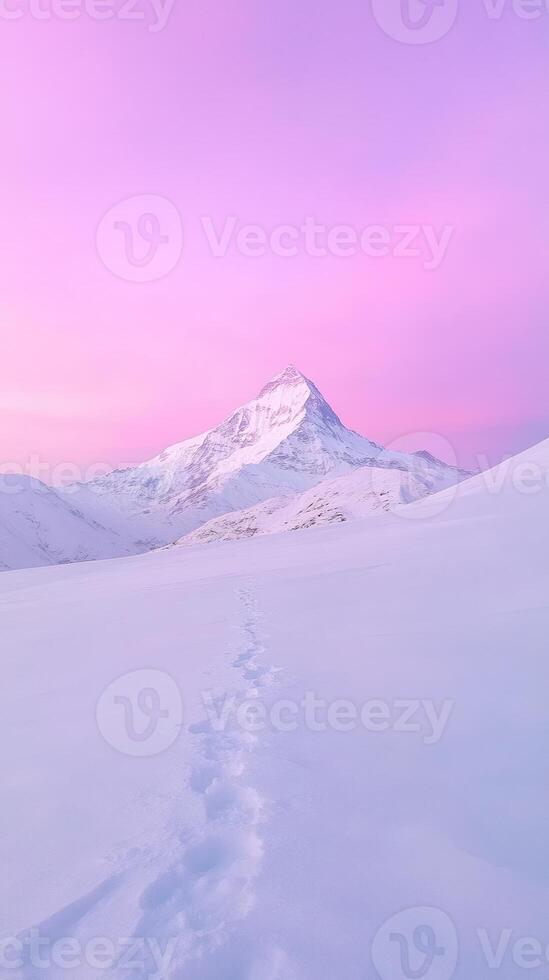 Snowy mountain peak under a vibrant pink sky with footprints leading through the pristine snow Winter landscape and adventure concept for exploration and nature design photo