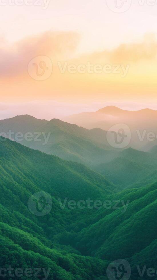Sunrise Over Lush Green Mountain Range Scenic Nature View in Vertical Composition with Soft Pastel Sky and Mist Covered Valleys for Serene Landscape Photography and Tranquil Meditation Settings photo