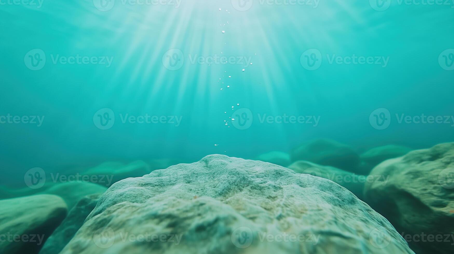 Underwater Bubbles Rising Towards Sunlit Surface with Light Rays Highlighting Rocks in Clear Aqua Water photo