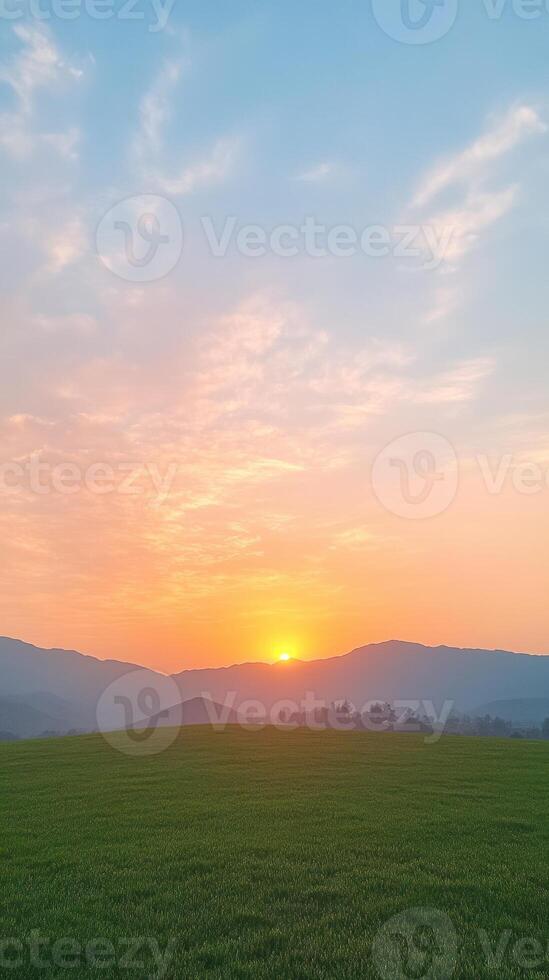 Beautiful Sunset Scene with Vibrant Colors and Cloudy Sky Over Green Field in Simi Valley Capturing Evening Tranquility and Natural Serenity as Sun Sets Behind Mountains photo