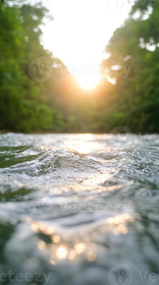 Tranquil Vertical View of Sunlit River with Rippling Waves Amidst Lush Green Forest, Capturing the Dramatic Interaction of Light and Water in Natures Serenity photo
