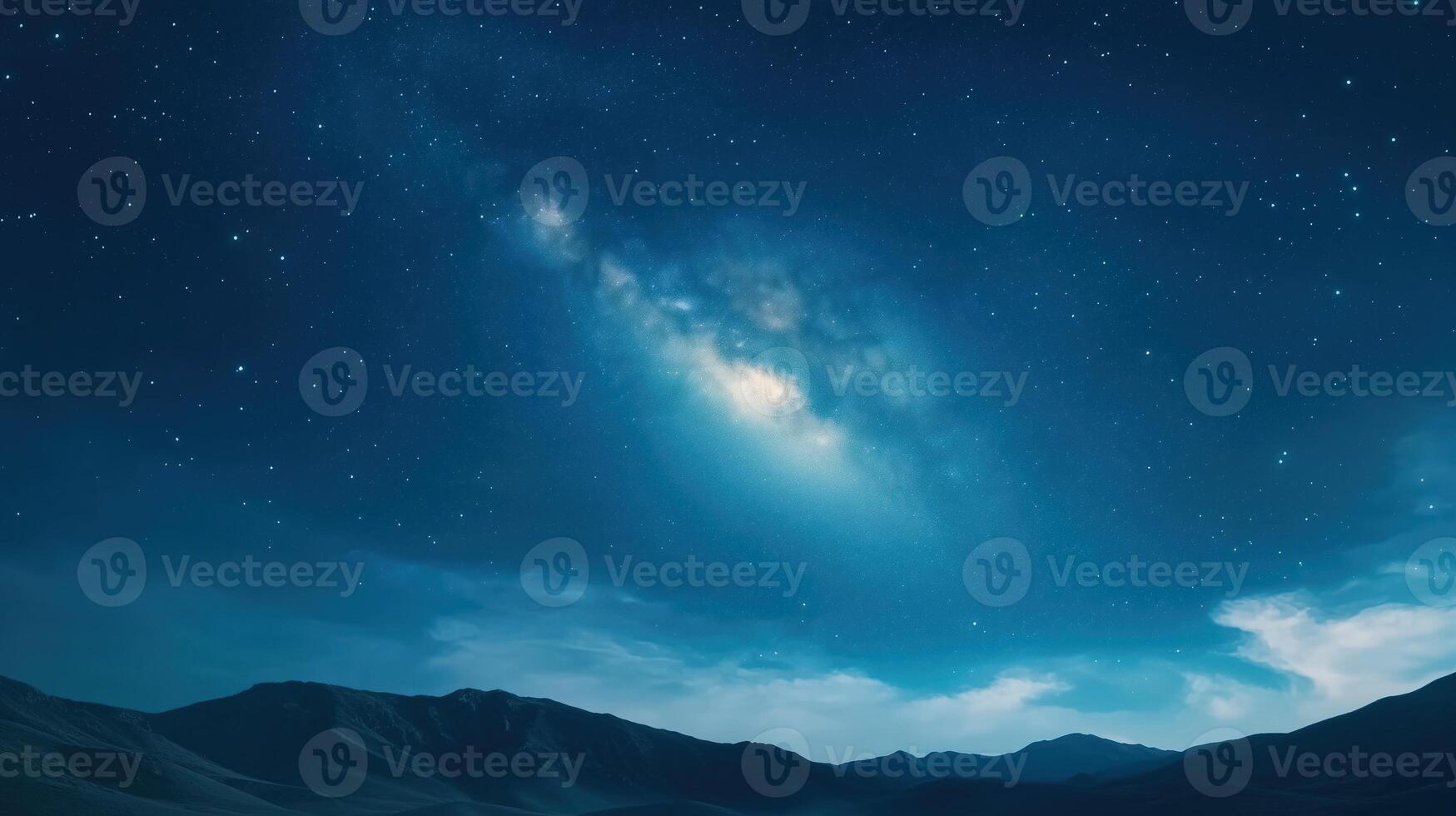 Starry night sky with a glowing Milky Way over a silhouette of mountains Cosmic scene capturing the vastness of space and natural nighttime beauty photo