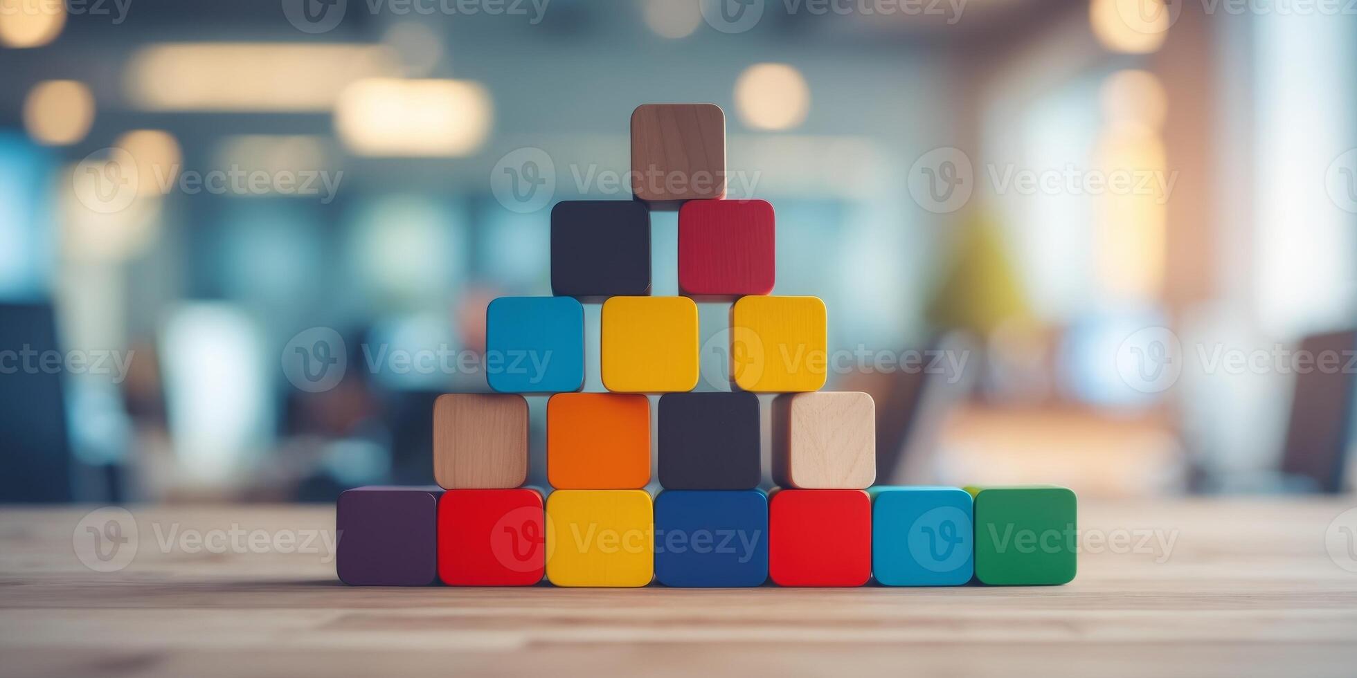 Colorful wooden building blocks representing teamwork and collaboration with a blurred workspace background emphasizing business concepts and growth strategies photo