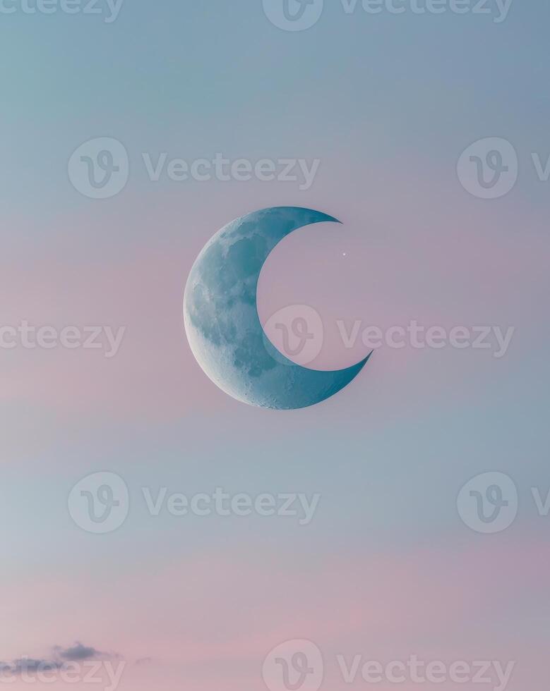 Crescent Moon Gleaming in a Twilight Sky photo