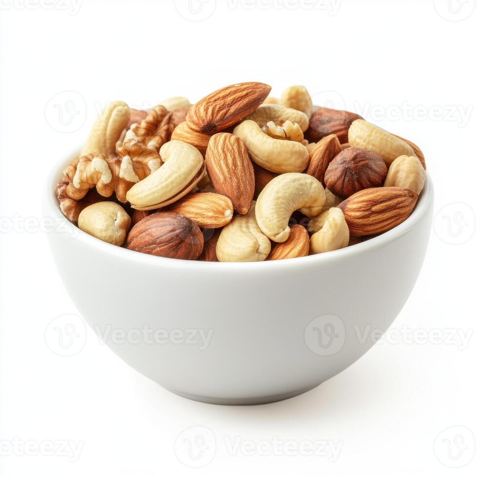 Variety of mixed nuts in a white bowl on a plain background for healthy snacking or culinary use photo