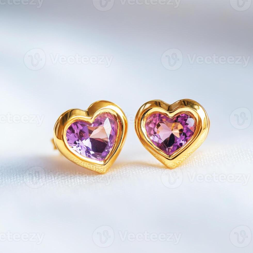 Heart-shaped gold earrings with purple gemstones shining under soft light photo