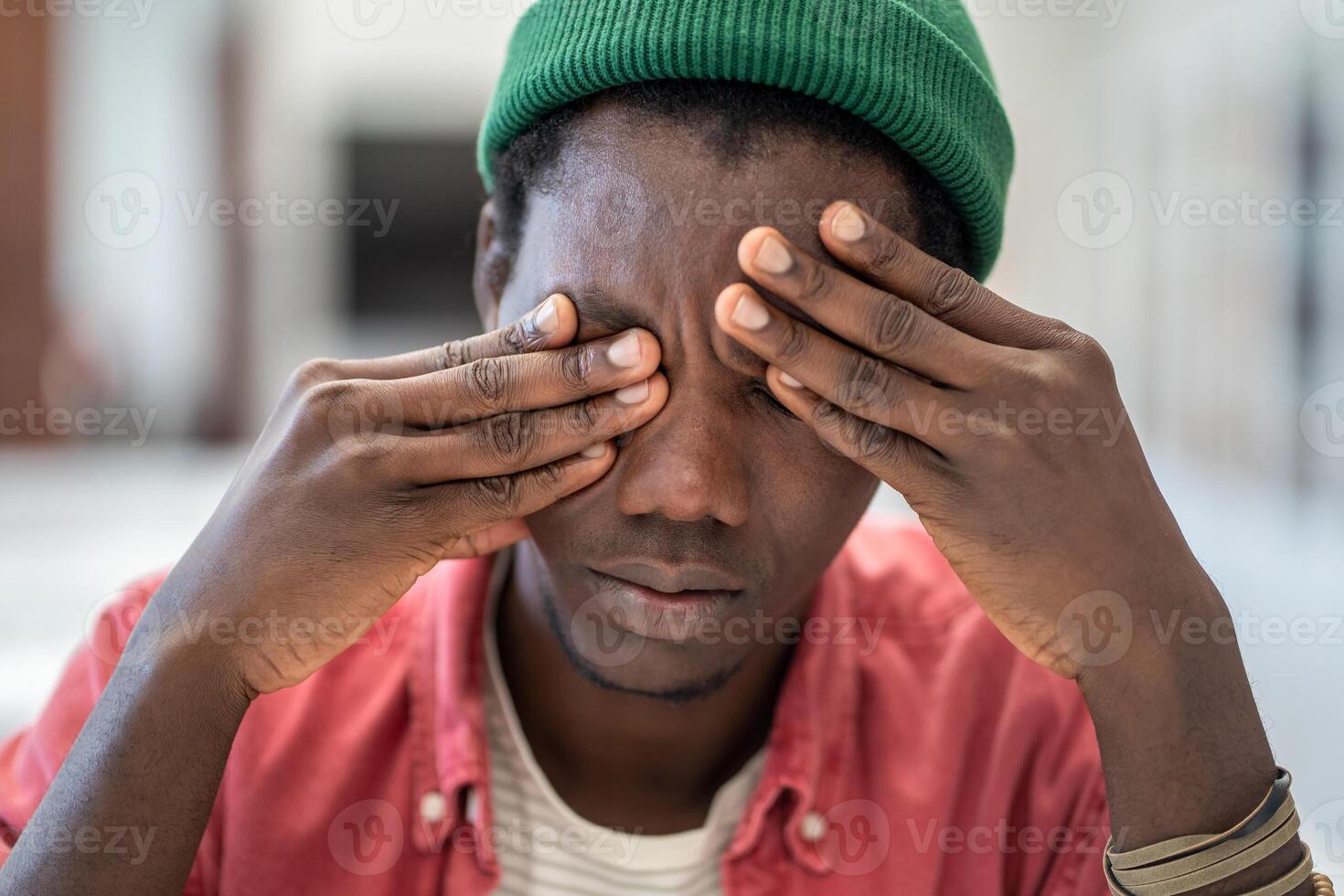 Fatigued black man feel dizzy from overwork lack of sleep eye strain exhausted after long laptop use photo